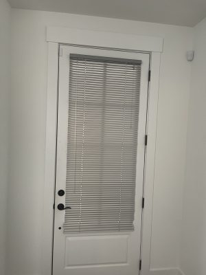 Aluminum mini blinds on a back door in an Atlanta home