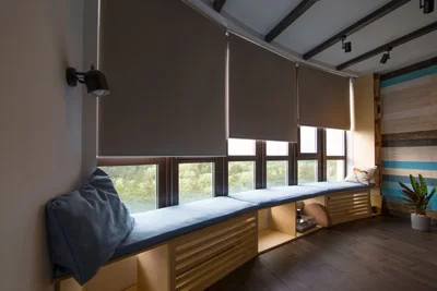Roller shade installed over a window seat